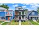 Stunning three-story home with modern design, balconies, and beautiful landscaping at 1218 Orange St, Indianapolis, IN 46203