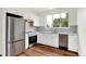Bright kitchen featuring stainless steel appliances, white cabinets, and a large window with a pleasant view at 1218 Orange St, Indianapolis, IN 46203