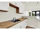Well-lit kitchen featuring light-colored cabinets, a butcher block countertop, and stainless steel sink at 1218 Orange St, Indianapolis, IN 46203