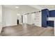 Open living space with modern flooring, sliding doors, and blue kitchen cabinets at 1218 Orange St, Indianapolis, IN 46203