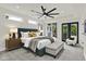 Beautiful main bedroom with modern ceiling fan, a private balcony, and large bed at 1218 Orange St, Indianapolis, IN 46203