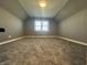 Finished attic space featuring carpeted floors and a window for natural light at 1702 Barth Ave, Indianapolis, IN 46203