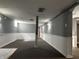 Finished basement with dark carpet, gray walls, wainscotting, and a support column at 1702 Barth Ave, Indianapolis, IN 46203
