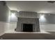 Finished basement featuring a stone fireplace with black metal screen and gray brick surround at 1702 Barth Ave, Indianapolis, IN 46203