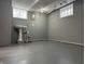 Finished basement with a pedestal sink, gray walls, and a painted gray floor at 1702 Barth Ave, Indianapolis, IN 46203