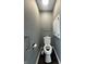 Small half bathroom with gray walls, storage cabinet, stainless steel fixtures and dark wood floors at 1702 Barth Ave, Indianapolis, IN 46203