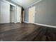 This bedroom features woodgrain floors, gray walls, white doors, and plenty of natural light at 1702 Barth Ave, Indianapolis, IN 46203