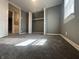 Carpeted room with gray walls, white trim, and window with natural light at 1702 Barth Ave, Indianapolis, IN 46203