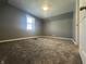 Bedroom featuring neutral walls, plush carpeting, a window for natural light, and baseboard trim at 1702 Barth Ave, Indianapolis, IN 46203
