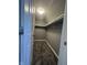 A closet with carpeted floors, a shelf, and ample storage space at 1702 Barth Ave, Indianapolis, IN 46203