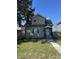 Charming two-story home featuring a well-maintained lawn and inviting entryway at 1702 Barth Ave, Indianapolis, IN 46203