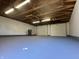 Clean, bright, and empty garage interior with three white garage doors and high ceilings at 1702 Barth Ave, Indianapolis, IN 46203