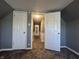 Upstairs hallway view features neutral carpet and wall colors plus white doors and trim at 1702 Barth Ave, Indianapolis, IN 46203