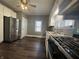 Updated kitchen with stainless steel refrigerator, a gas range, and lots of cabinet space at 1702 Barth Ave, Indianapolis, IN 46203