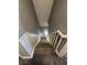 A bird's eye view of the carpeted staircase with white painted railings at 1702 Barth Ave, Indianapolis, IN 46203