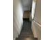 A stairwell leading to the basement with painted stairs and walls at 1702 Barth Ave, Indianapolis, IN 46203