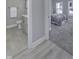 Neutral bathroom featuring tile floors, a toilet, and a vanity with sink, adjacent to bedroom with gray carpet at 11451 Neptune Dr, Fishers, IN 46040