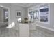 Bright dining area with a glass-top table, upholstered chairs, and a large window overlooking the outdoor patio at 11451 Neptune Dr, Fishers, IN 46040