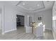 Bright dining area with a round glass table, white chairs, tray ceiling, and natural light from a window at 11451 Neptune Dr, Fishers, IN 46040
