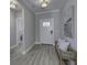 Welcoming entryway featuring light gray walls, wood-look floors, a front door, and a charming woven bench at 11451 Neptune Dr, Fishers, IN 46040