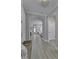 Bright hallway featuring gray walls, wood-look floors, archways leading into other rooms, and natural light at 11451 Neptune Dr, Fishers, IN 46040