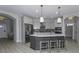 Stylish kitchen featuring a gray island with seating, modern appliances, and ample cabinet space at 11451 Neptune Dr, Fishers, IN 46040