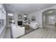 Bright living room featuring a fireplace, two sofas, neutral decor, and seamless flow into other living areas at 11451 Neptune Dr, Fishers, IN 46040