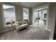 Light-filled sitting room features a cozy loveseat and seamless access to the outdoor patio through sliding glass doors at 11451 Neptune Dr, Fishers, IN 46040