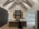 Modern kitchen featuring a large island, custom cabinetry, and exposed beam ceilings at 719 Wexford Hill Ct, Westfield, IN 46074