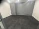 Empty room with black flooring and gray paneled accent wall at 719 Wexford Hill Ct, Westfield, IN 46074