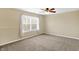 Bright bedroom with a neutral color palette, ceiling fan, and natural light from a large window at 1024 Rotherham Ln, Beech Grove, IN 46107