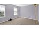 Bedroom with two large windows, neutral carpet, and ample natural light at 1024 Rotherham Ln, Beech Grove, IN 46107