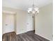 Dining room featuring wood-look floors, chandelier, and convenient access to two entryways at 1024 Rotherham Ln, Beech Grove, IN 46107