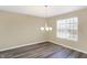 Bright dining area with wood-look flooring, chandelier and a window providing natural light at 1024 Rotherham Ln, Beech Grove, IN 46107