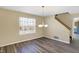 Dining area featuring wood-look flooring, chandelier, and a large window at 1024 Rotherham Ln, Beech Grove, IN 46107