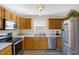 Bright eat-in kitchen with stainless steel appliances and window at 1024 Rotherham Ln, Beech Grove, IN 46107