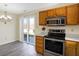 Eat-in kitchen featuring stainless steel appliances and a sliding door to the backyard at 1024 Rotherham Ln, Beech Grove, IN 46107