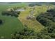 Breathtaking aerial perspective of estate showcasing lush land, pond, and mature tree coverage at 9083 W Koger Ln, Martinsville, IN 46151