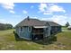 Aerial view of the backyard with outbuilding, patio, and deck at 9083 W Koger Ln, Martinsville, IN 46151