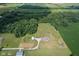 Stunning aerial view of a home with an expansive yard, mature trees, and charming landscaping at 9083 W Koger Ln, Martinsville, IN 46151