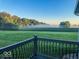 A cozy outdoor balcony view overlooks a green backyard with trees and misty air at 9083 W Koger Ln, Martinsville, IN 46151