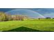 Enjoy serene views of a lush green backyard under a beautiful rainbow-an idyllic outdoor haven at 9083 W Koger Ln, Martinsville, IN 46151