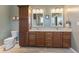 Well-lit bathroom featuring double sinks, granite counters, wood-look tile floor, and decorative wall art at 9083 W Koger Ln, Martinsville, IN 46151