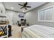 Bedroom featuring a painted brick wall, ceiling fan, and a window at 9083 W Koger Ln, Martinsville, IN 46151