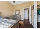 Neutral bedroom with a wood dresser, bedside table, and an open closet with hanging clothes at 9083 W Koger Ln, Martinsville, IN 46151