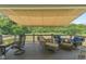 Spacious deck featuring an awning, outdoor dining and lounging furniture, and lovely wooded views at 9083 W Koger Ln, Martinsville, IN 46151