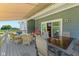 Relaxing deck with wicker furniture, retractable awning, and peaceful views of the neighboring field at 9083 W Koger Ln, Martinsville, IN 46151