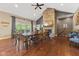 Spacious dining room featuring stone fireplace, vaulted ceilings, and large wood table at 9083 W Koger Ln, Martinsville, IN 46151