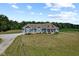 Charming blue two-story home with well-manicured lawn and gravel driveway at 9083 W Koger Ln, Martinsville, IN 46151