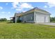 Side view of home featuring 3-car garage, deck, and yard at 9083 W Koger Ln, Martinsville, IN 46151